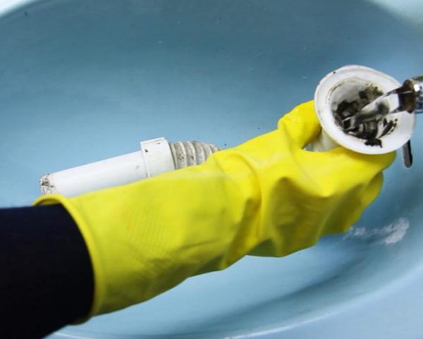 Промывание разобранного сифона водой